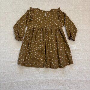 Jamie Kay tan long sleeve dress with cream flowers, ruffled shoulders and wrists